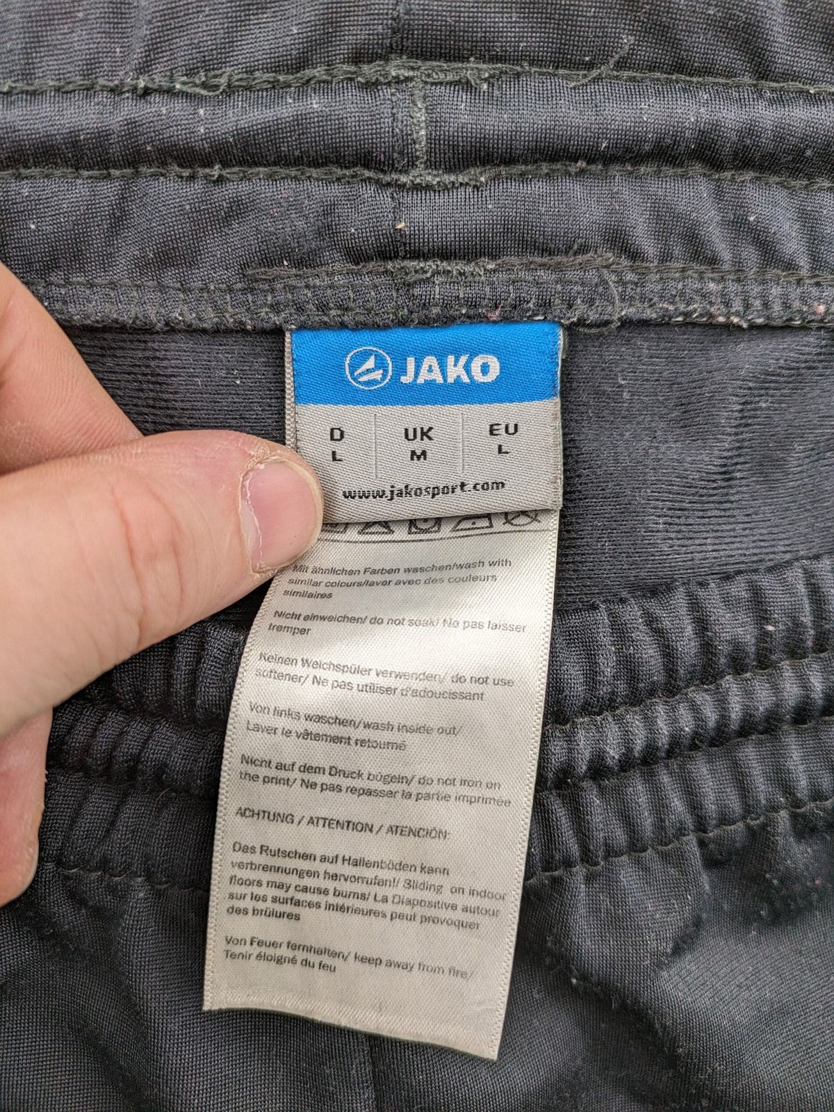 Jako black training pants size L with zippered pockets and elastic waistband.
