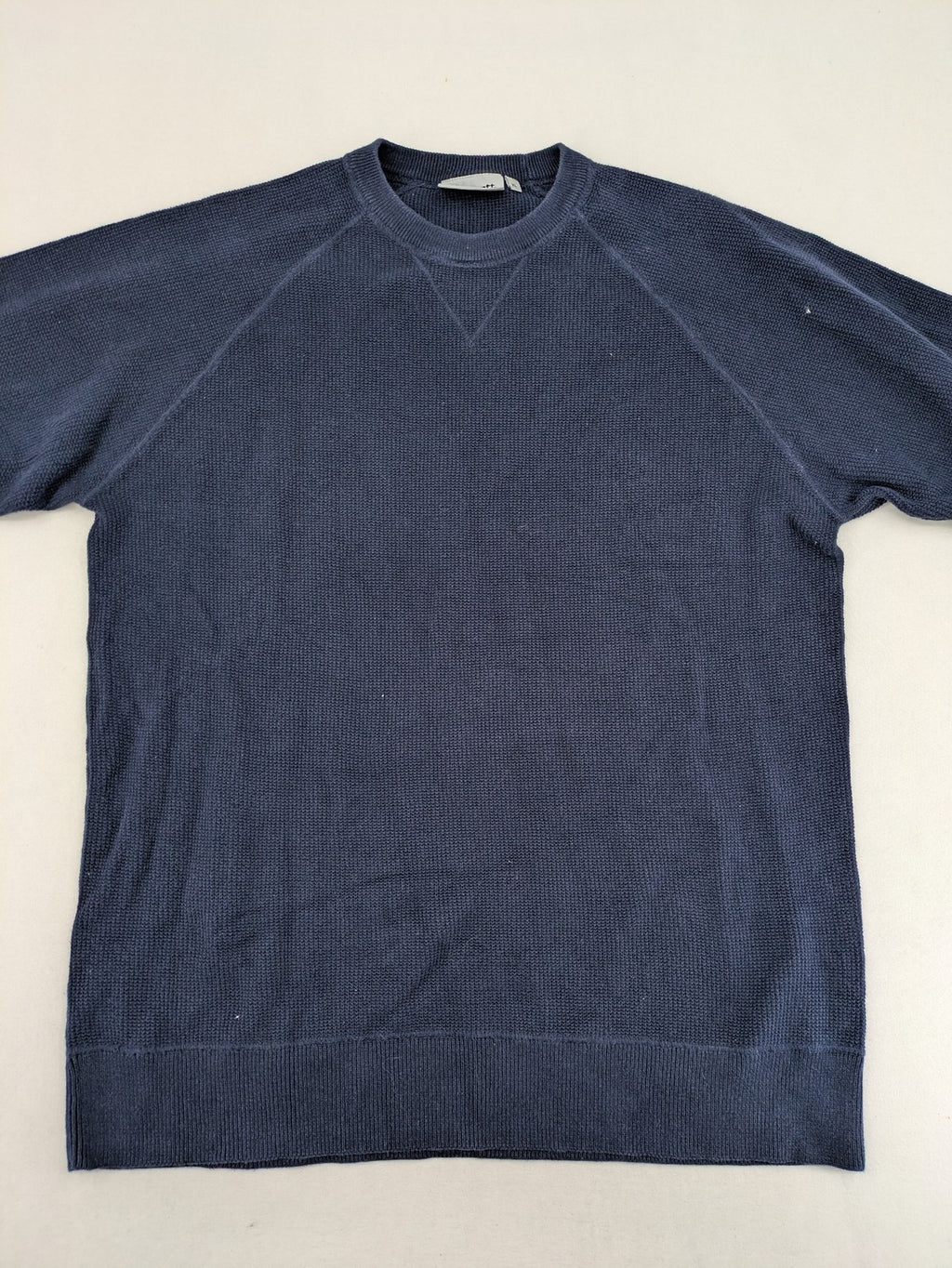 Carhartt navy turtle neck jumper waffle knit texture with subtle logo on sleeve.