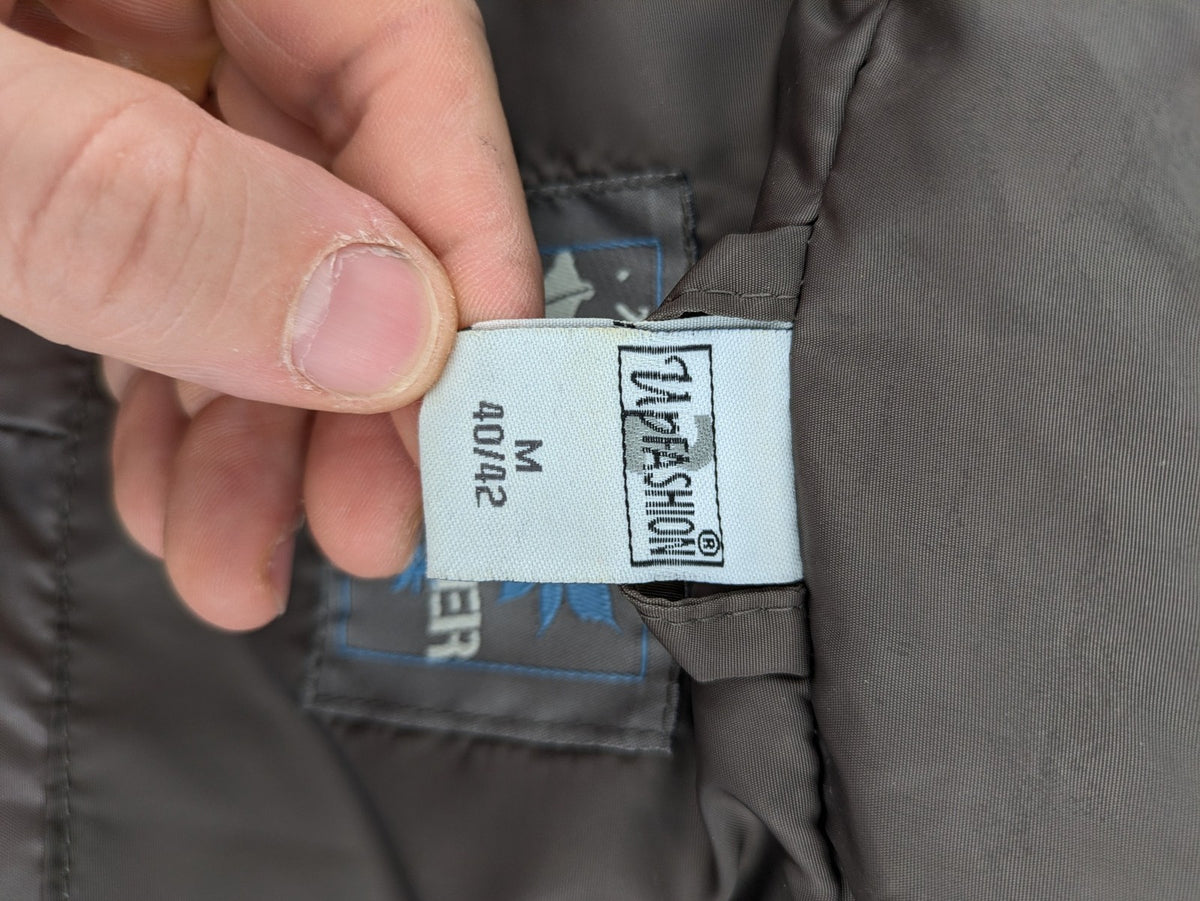 L&A Fashion grey puffer vest with zip closure, stand collar, and side pockets.