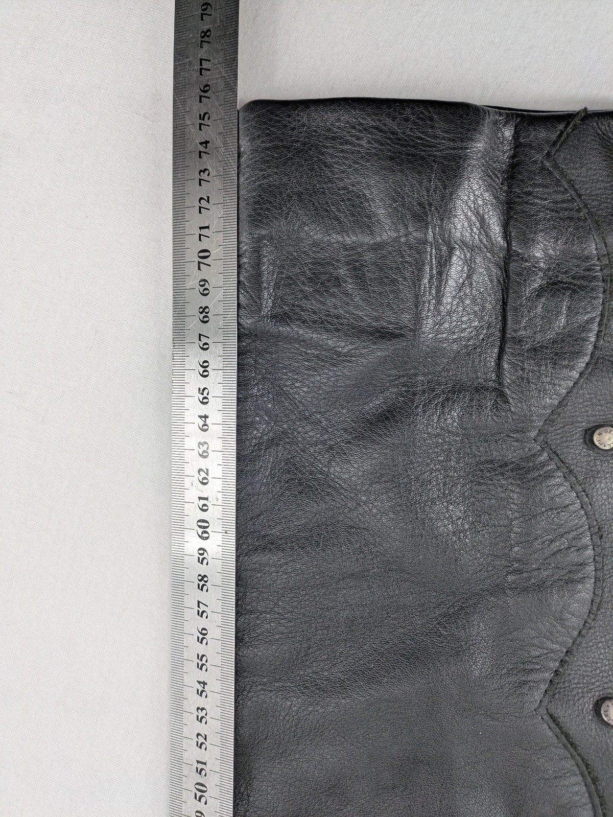 Hein Gericke black leather chaps with studs and wavy decorative seams.