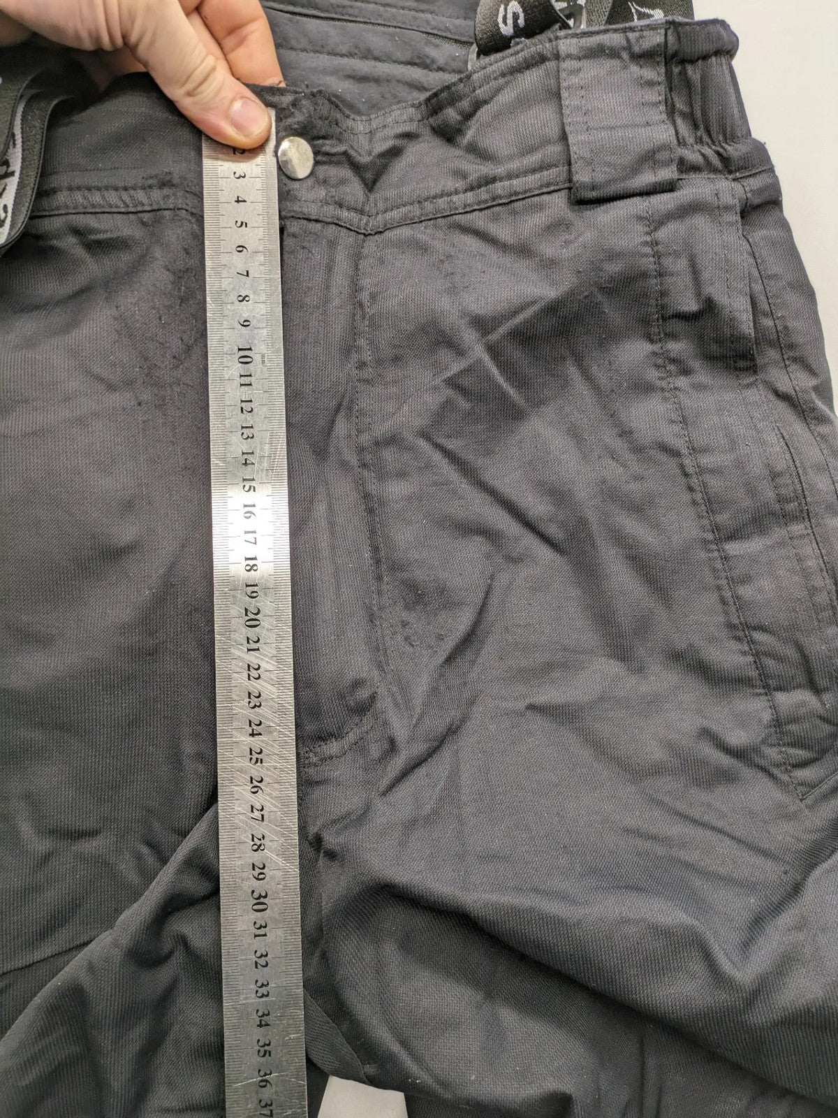 Schoffel black ski pants with adjustable straps, zip pockets, and snow gaiters.