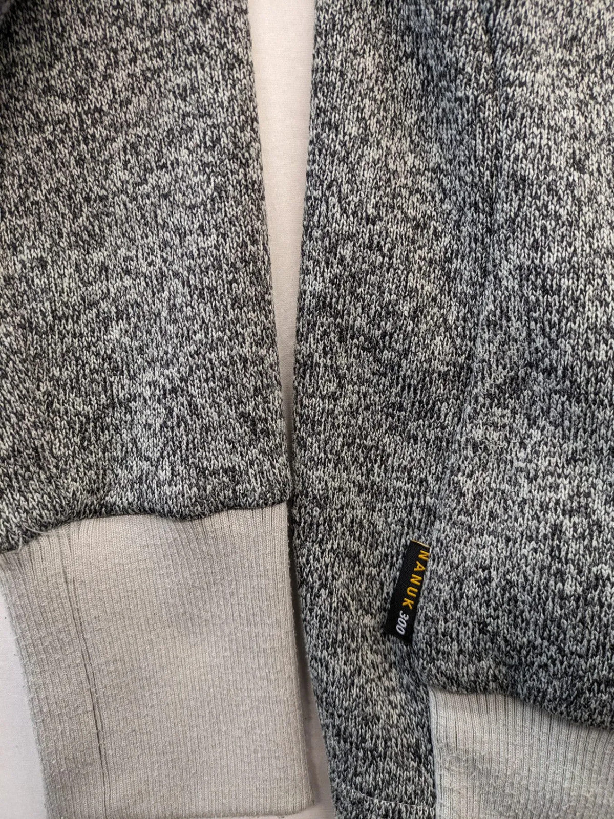 Jack Wolfskin grey fleece jacket with logo detailing and two front pockets.