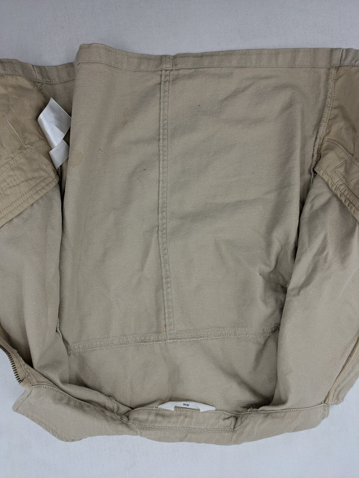 H&M beige twill coat with full zip, classic collar, and practical pockets.