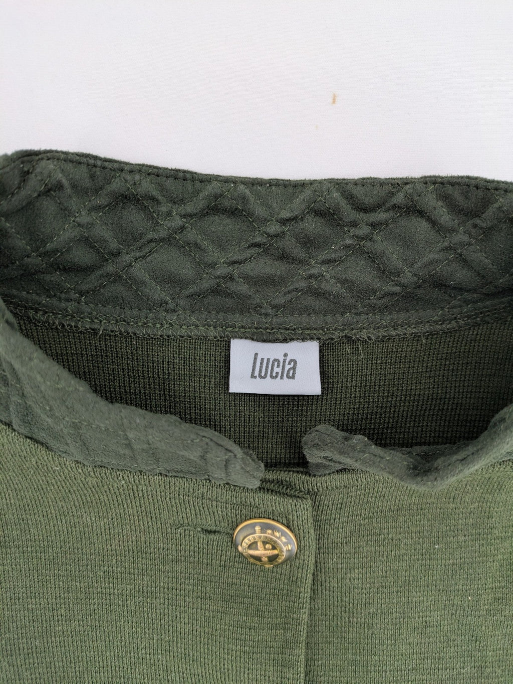 LUCIA green Trachtenjacke with embroidered crest, quilted collar, and decorative buttons.