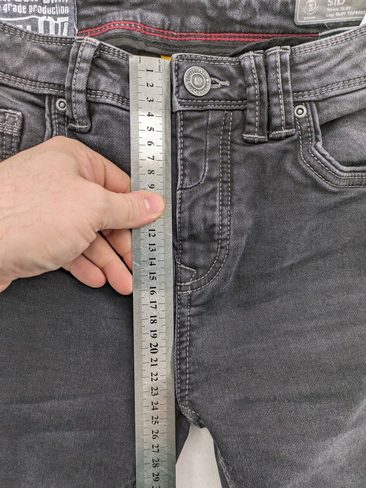 Tom Tompson grey slim tapered jeans with washed denim finish and subtle branding.