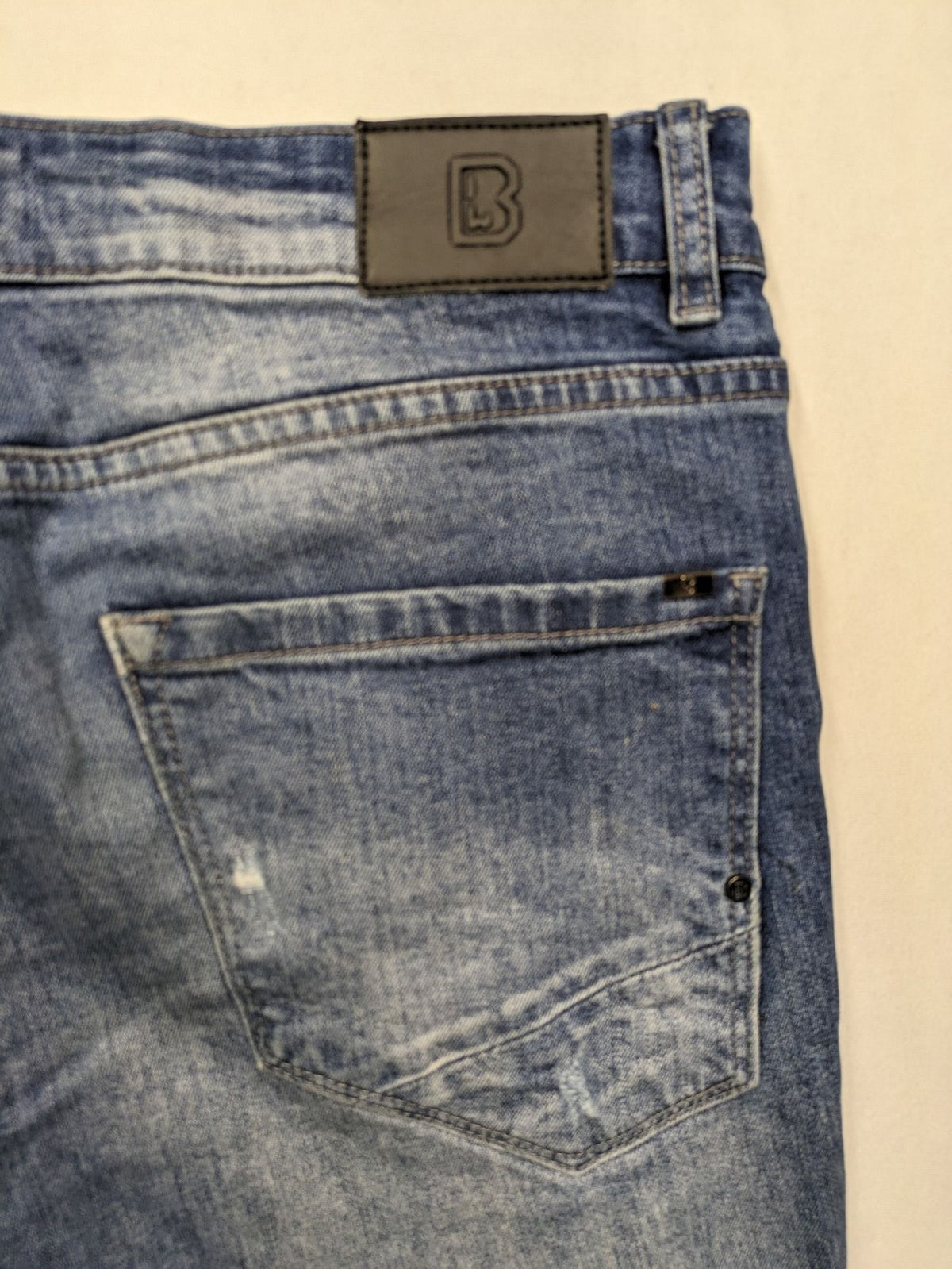 Brandit blue straight jeans with distressed details, button fly, and classic 5-pocket style.