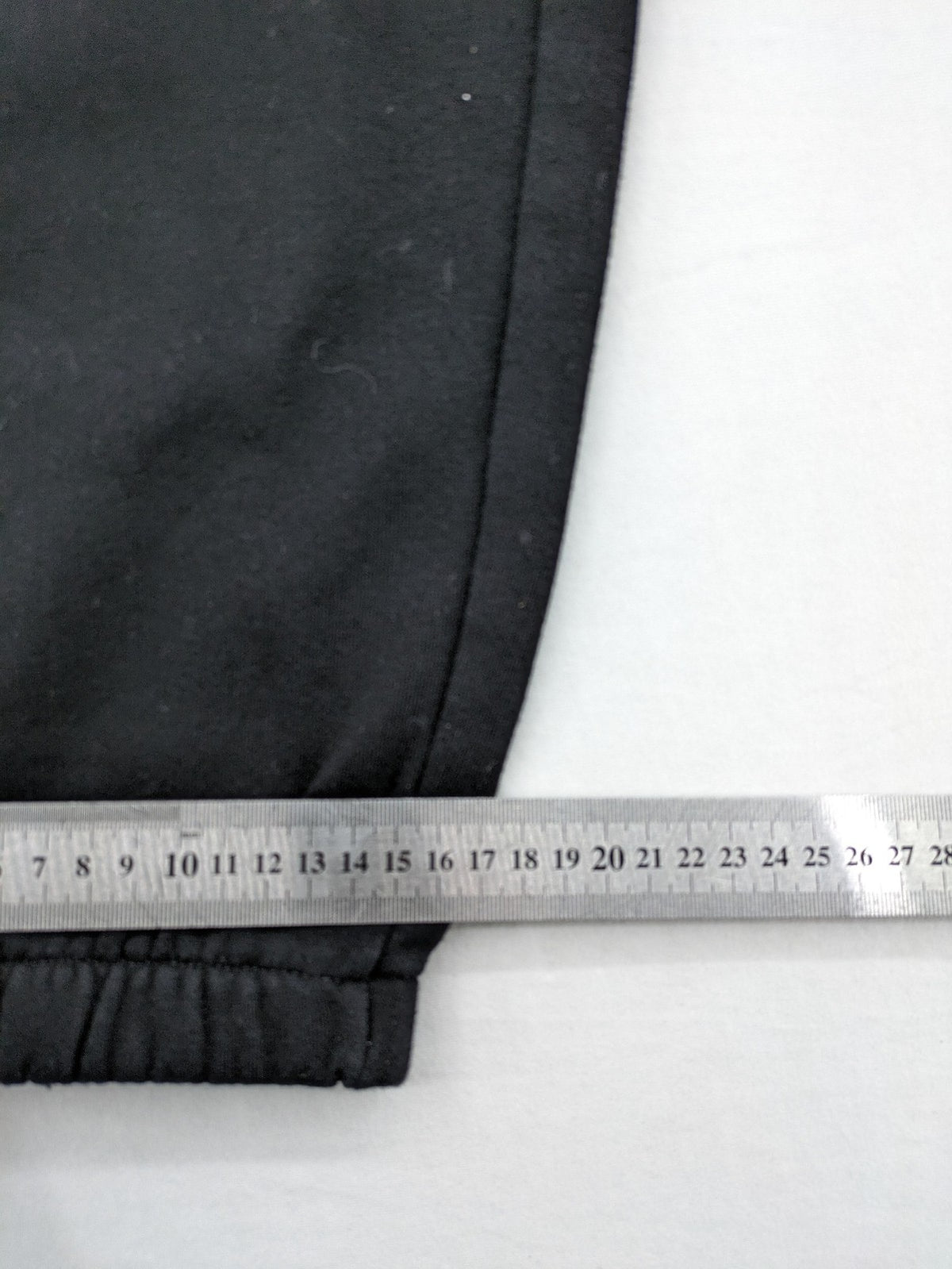 H&M black sweatpants with adjustable drawstring, elastic cuffs, and side pockets.