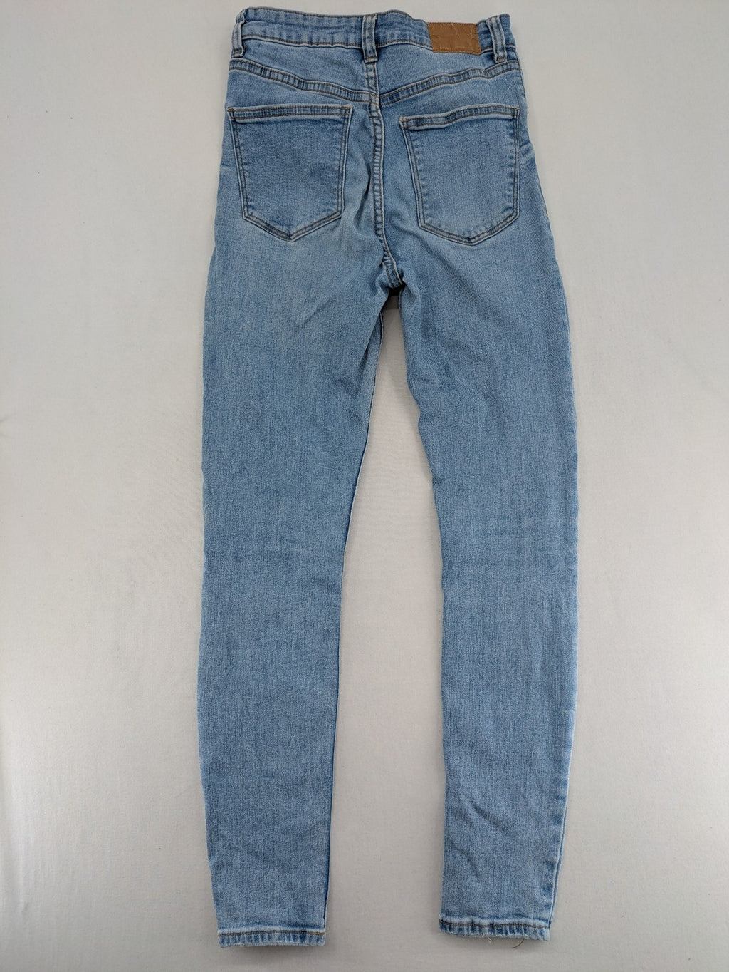 Bershka blue super high waist skinny jeans with washed denim finish and zip closure.