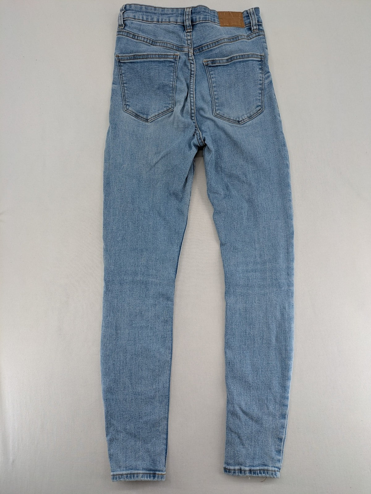 Bershka blue super high waist skinny jeans with washed denim finish and zip closure.