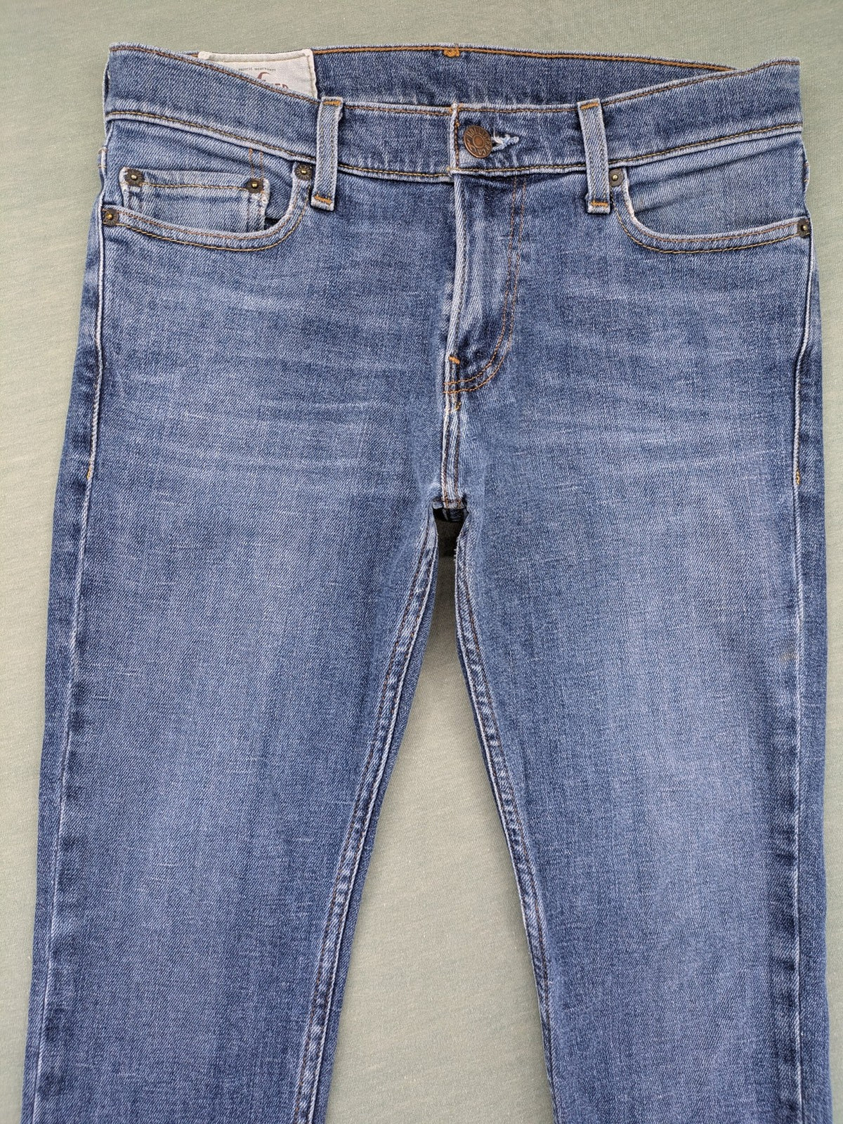 Hollister blue slim fit jeans with classic 5-pocket design and stretch denim material.