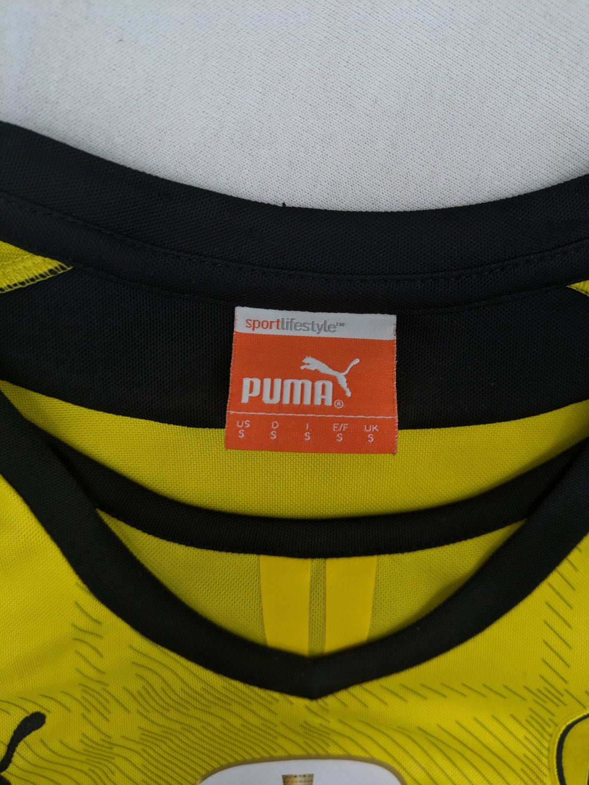 Borussia Dortmund black and yellow soccer uniform with DFB Pokal 2014 patch and Puma logo.