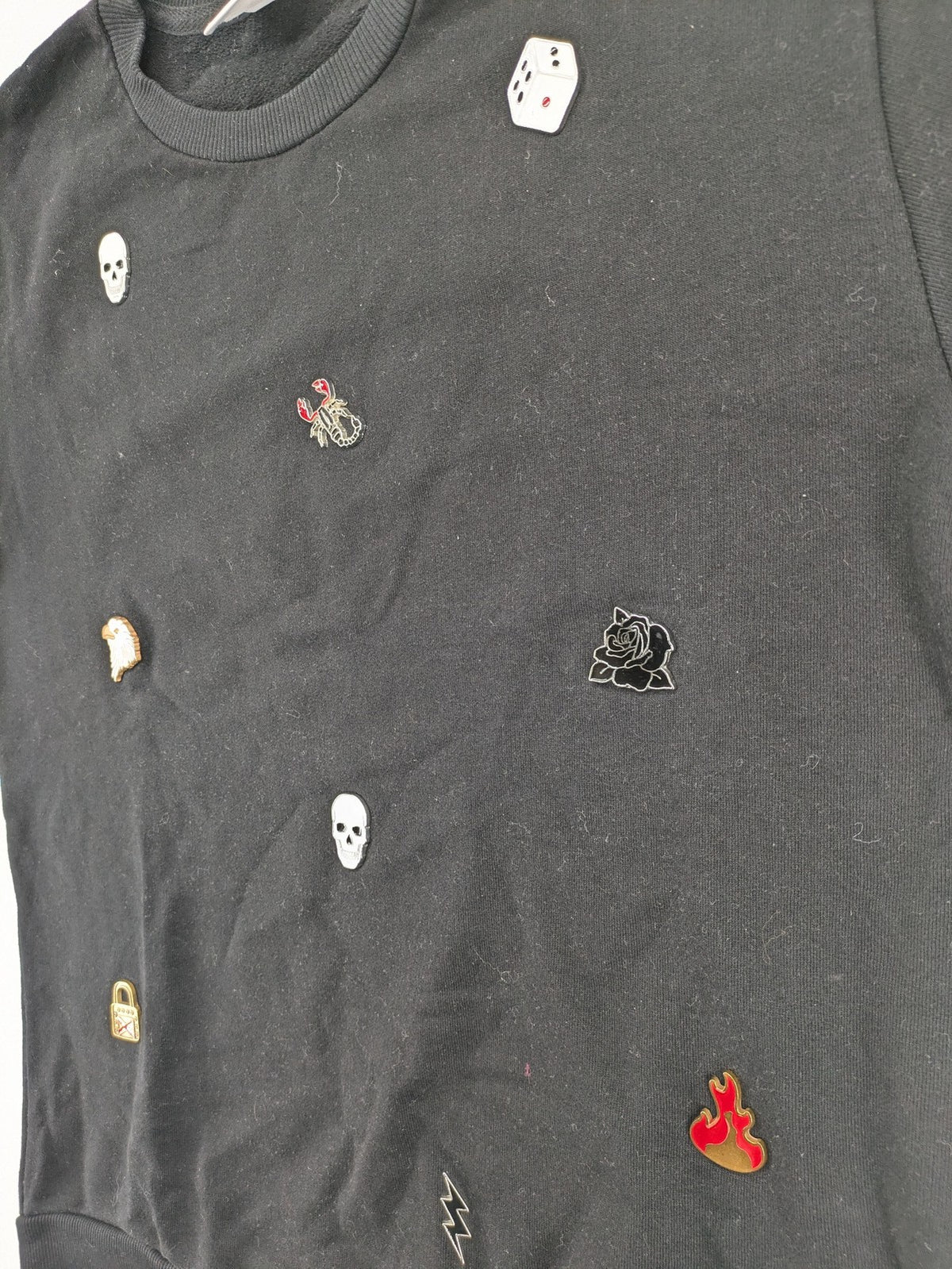 Zara grey turtle neck jumper with skull, scorpion, flame, and eagle embellishments.