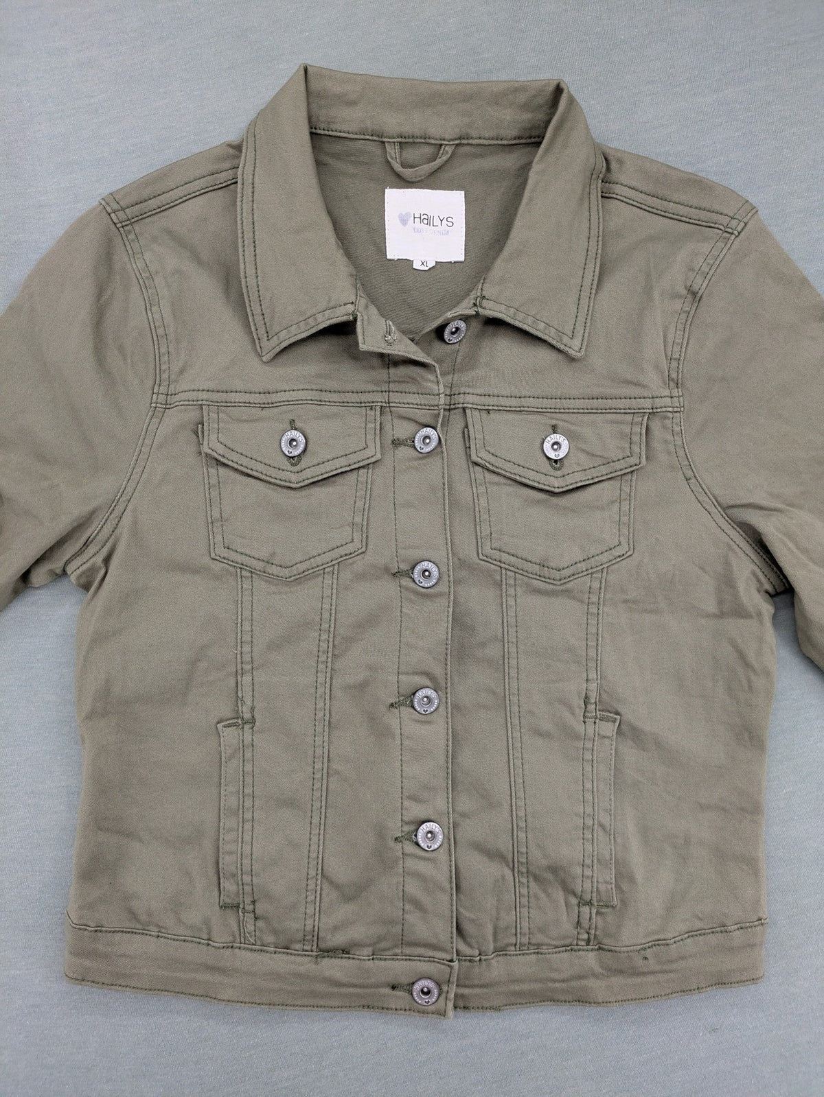 Hailys khaki denim jacket with button closure, two chest pockets, and side pockets.
