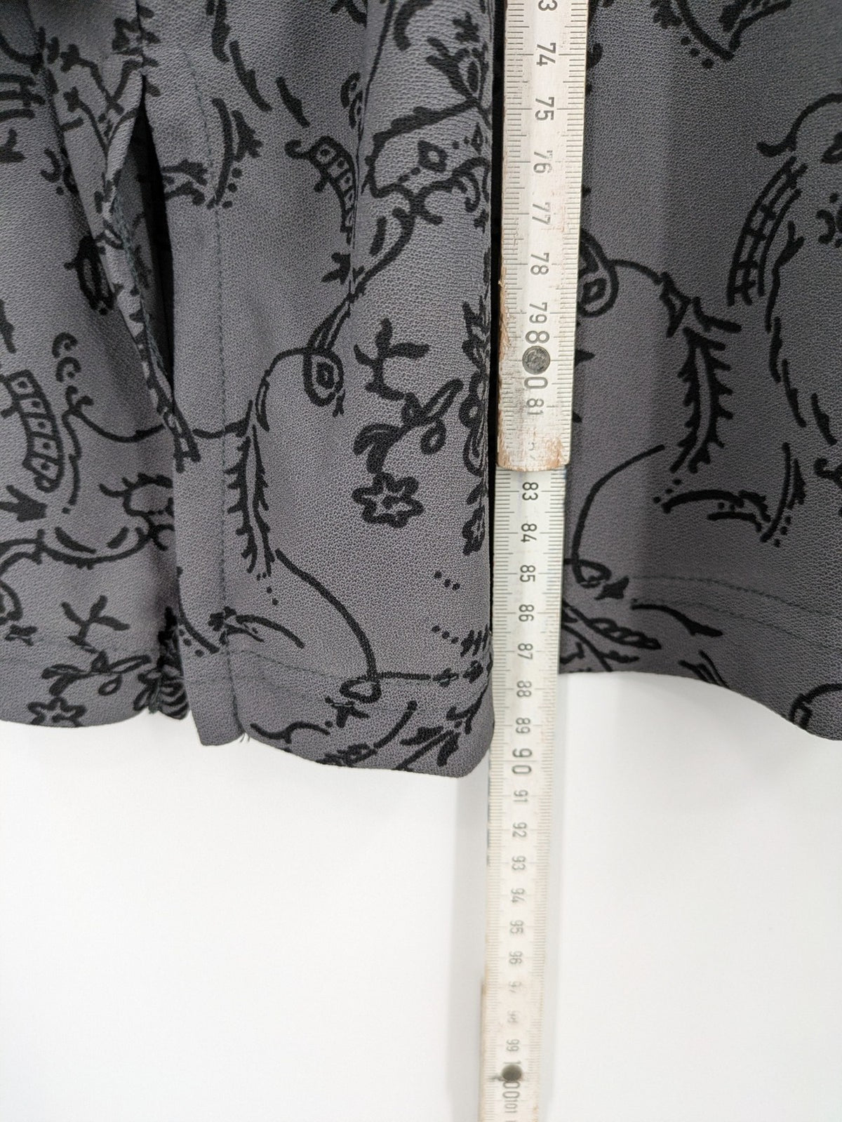 Yessica grey black floral pattern tunic top with round neckline and long sleeves.