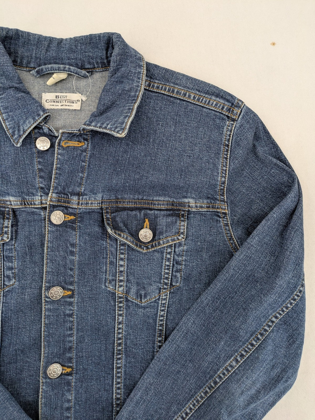 Best Connections cream denim jacket classic design with button placket and two chest pockets.