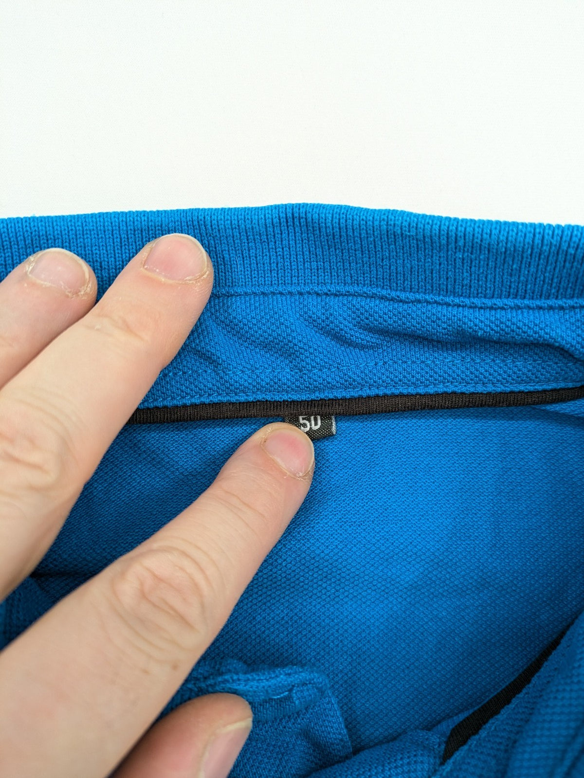 Aldi blue long sleeve polo shirt with embroidered logo and classic collar.