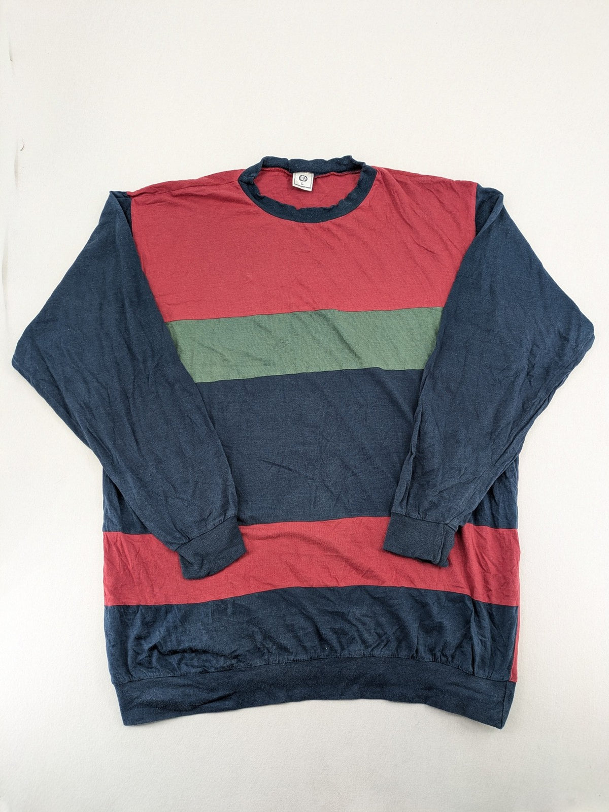 C&A green navy red colorblock long sleeve top with wide striped pattern and round neckline.