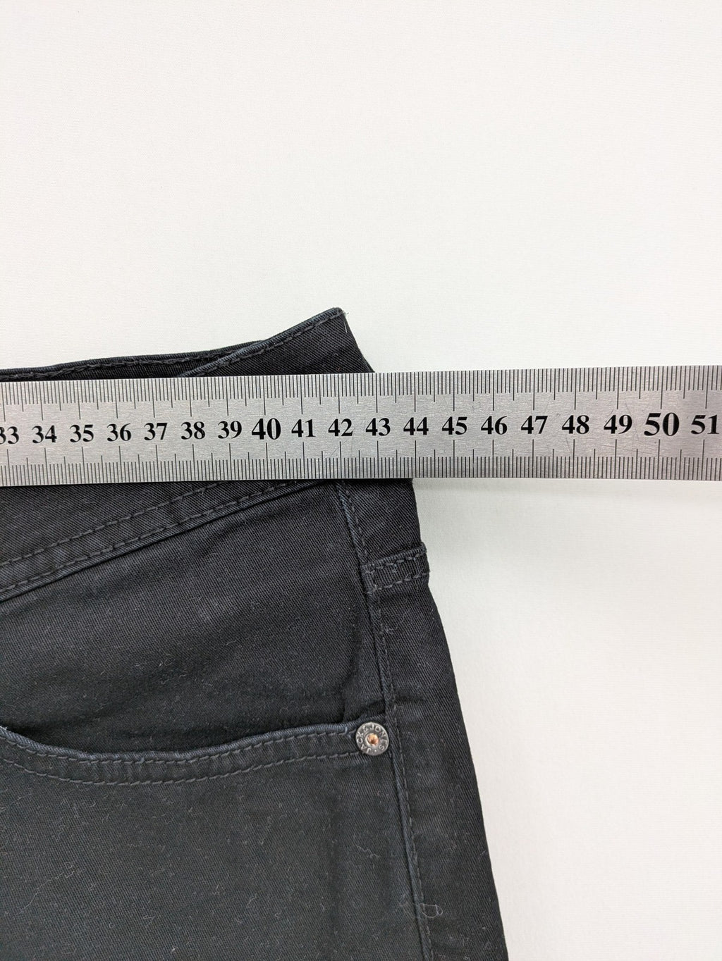 Jack & Jones black slim fit jeans with logo patch and cotton-stretch blend.