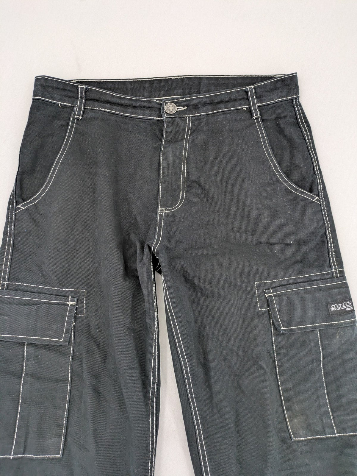 FSBN black baggy cargo pants with white contrast stitching and multiple pockets.