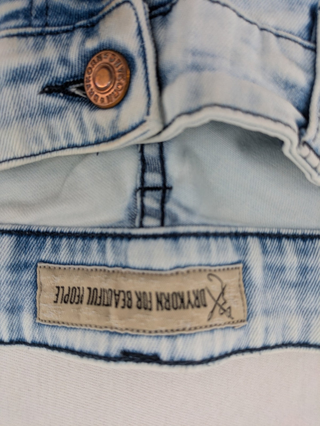 Drykorn blue slim fit jeans with acid wash and leather logo patch.