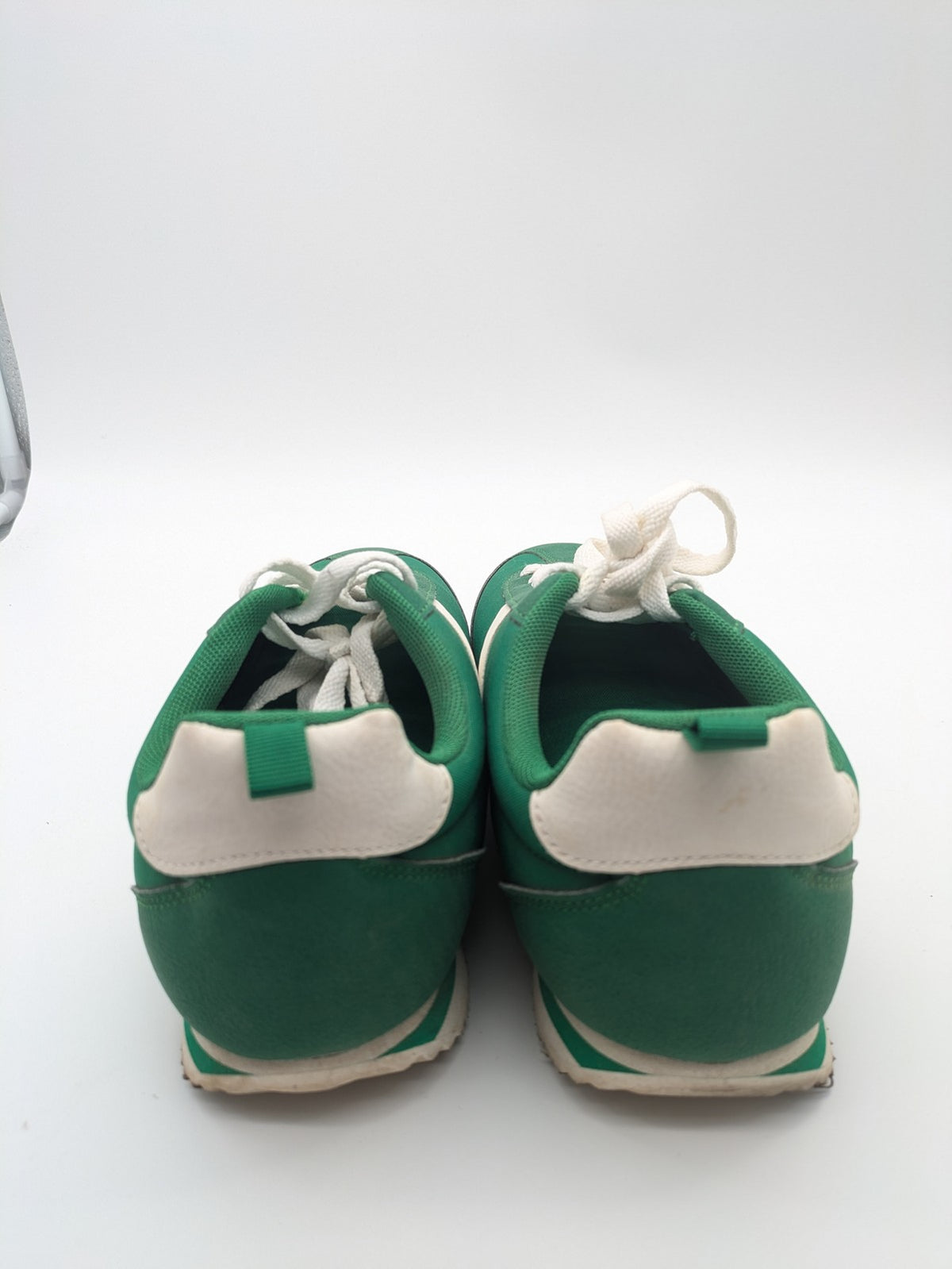 Primark green and white retro sneakers with classic lace-up design and textured rubber sole.