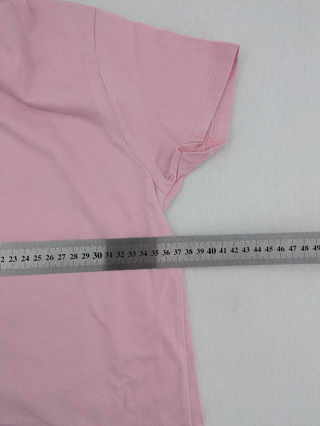 Marilyn Manson pink band t-shirt with colorful graphic portrait and "MM" logo.
