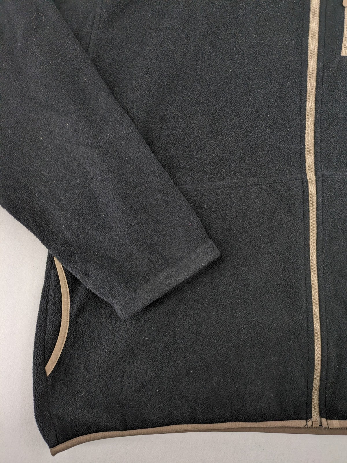 Crane beige and black fleece jacket full zip with cream accents and zippered pockets.