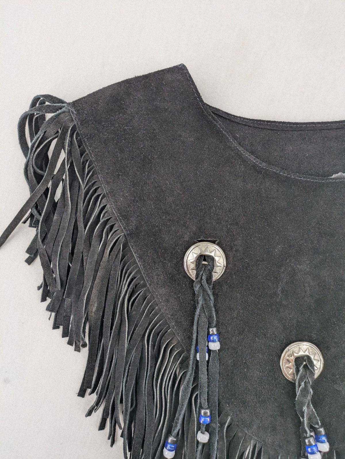 Stars & Stripes black suede fringe vest with silver conchos and beaded tassels.