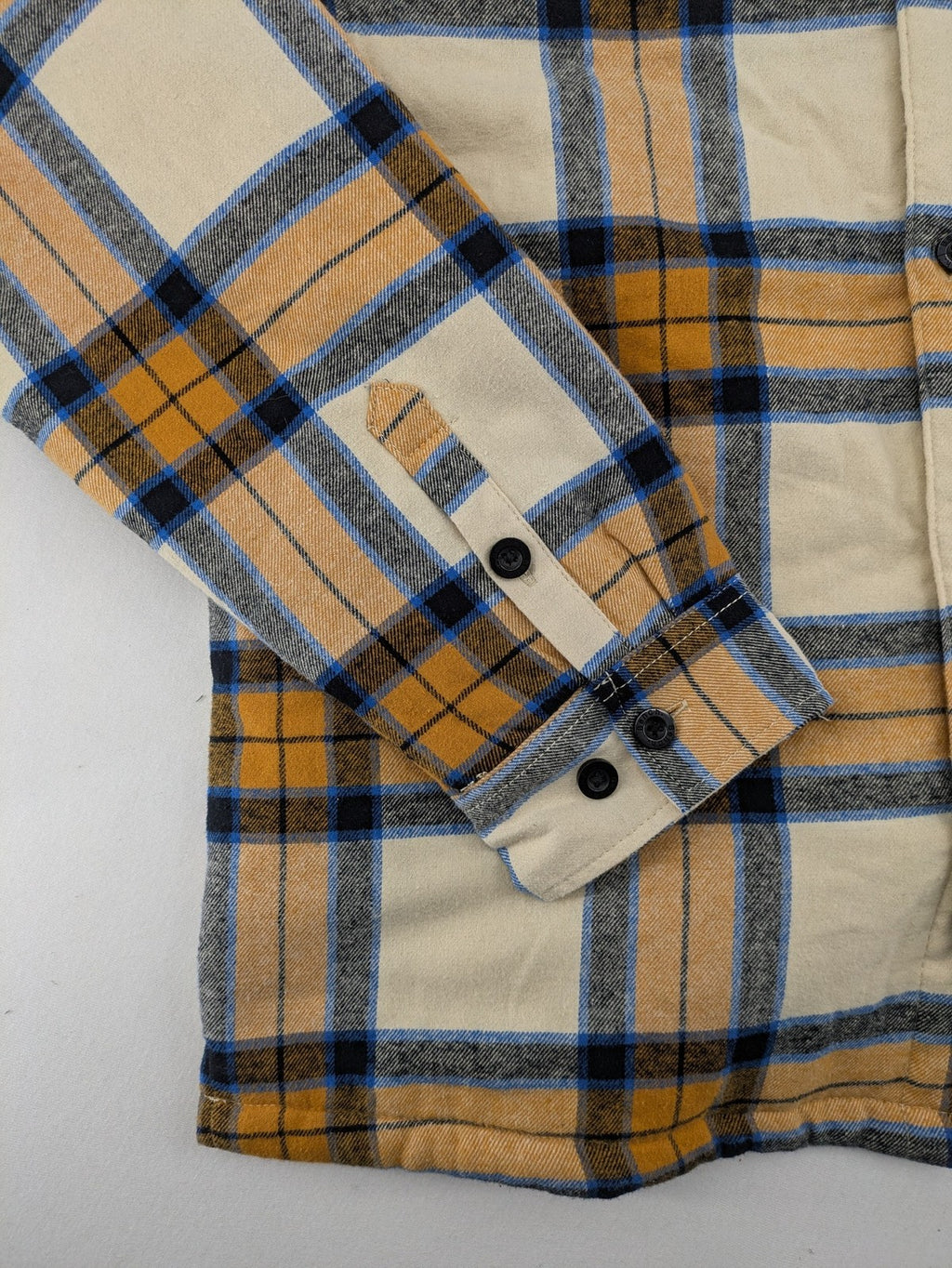 Bench cream flannel jacket with check pattern, black hood, and button placket.