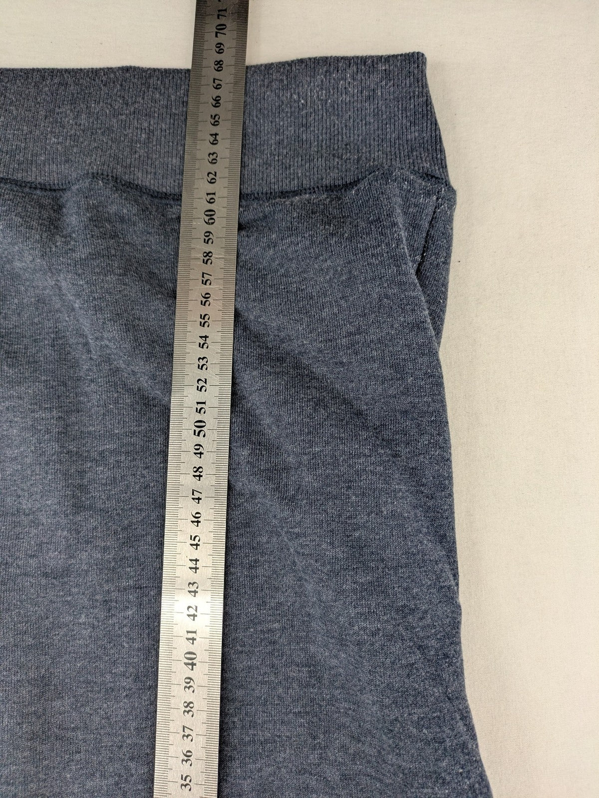 Tommy Jeans blue full zip hoodie with logo, adjustable hood, and kangaroo pockets.