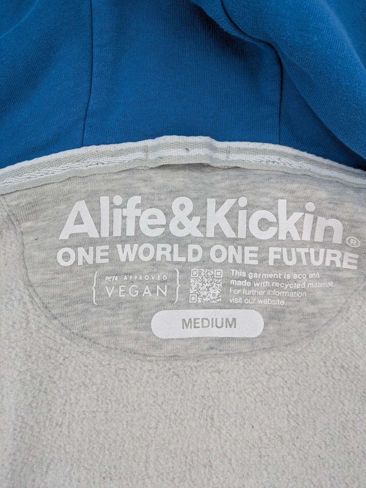 ALIFE turtle neck jumper blue grey colorblock design with logo details and soft cotton blend.