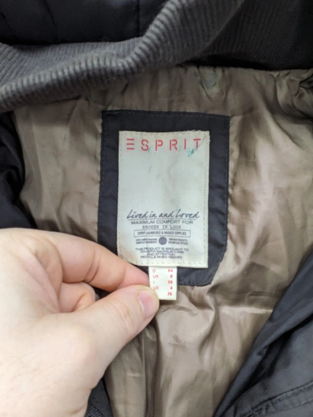 Esprit black quilted coat with removable faux fur hood and elastic waist belt.