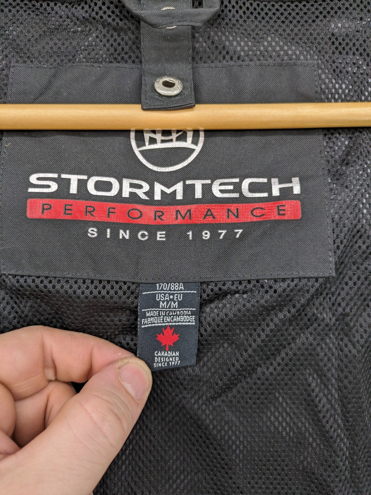 Stormtech black waterproof jacket with ZF logo, H2Xtreme technology, front zipper, and hood.