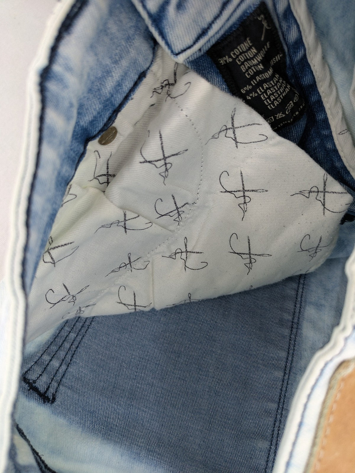 Drykorn blue slim fit jeans with acid wash and leather logo patch.