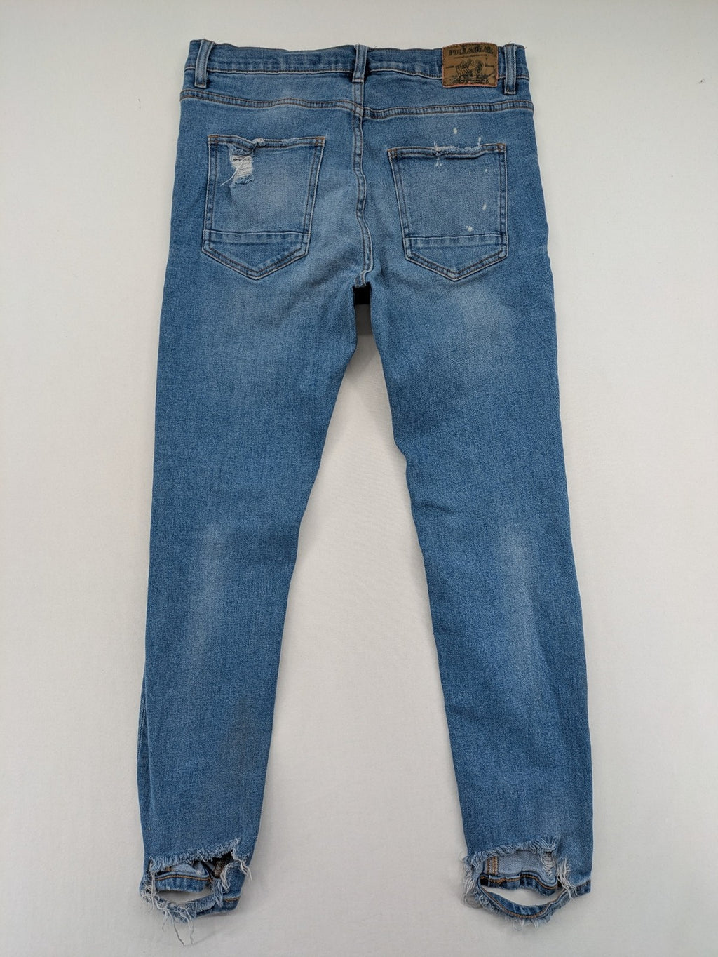 Pull&Bear blue carrot fit jeans with distressed knees and frayed hems.