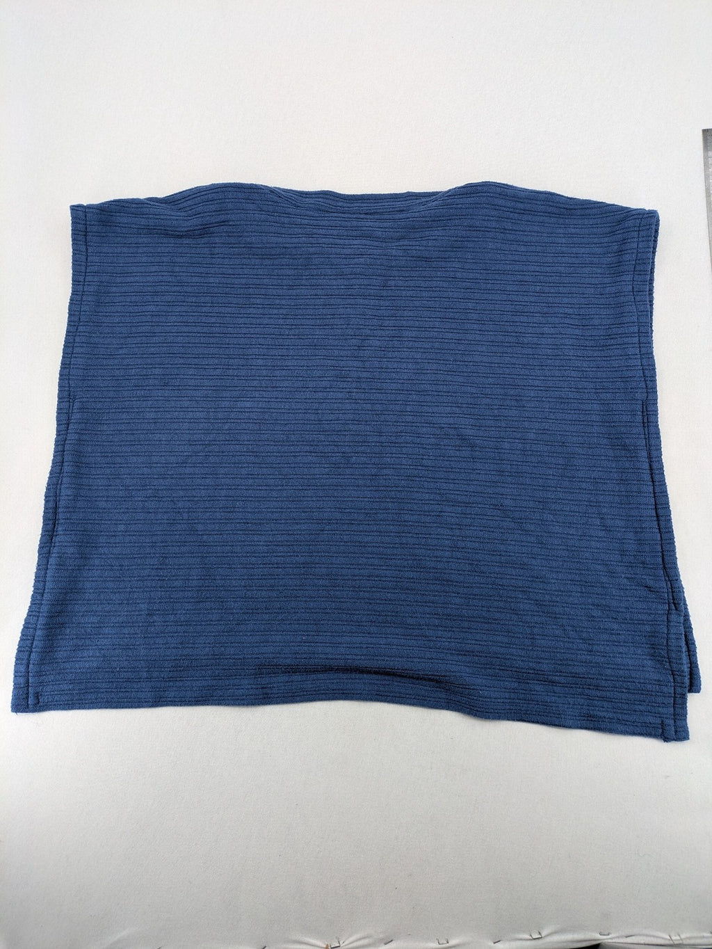 Secondhand blue tank top with ribbed texture and colorful decorative buttons.