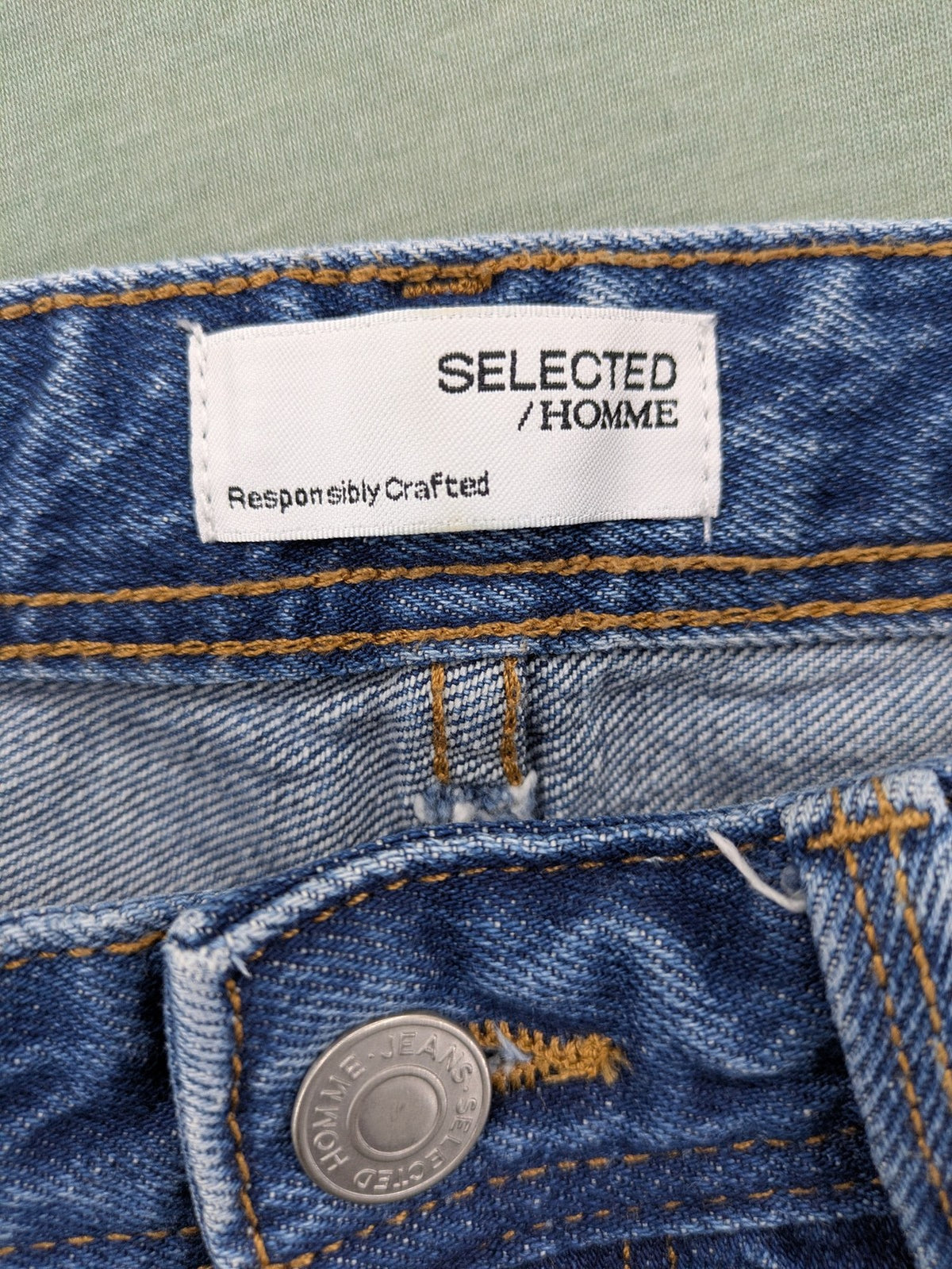 Selected Homme blue straight fit jeans with classic five-pocket design and medium wash denim.