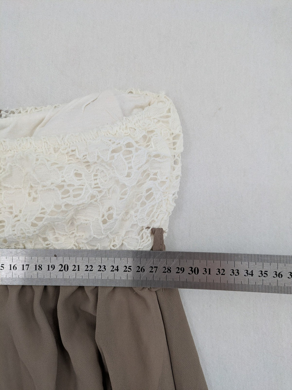 Creme bandeau summer dress in taupe with lace top and decorative gold buttons.