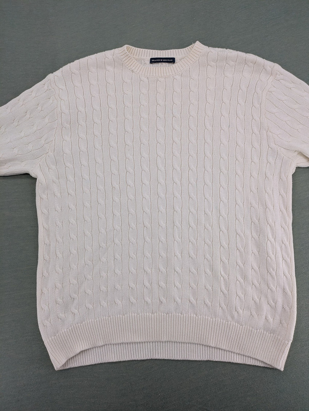 Brandy Melville cream turtle neck jumper with allover cable knit pattern and ribbed hem.