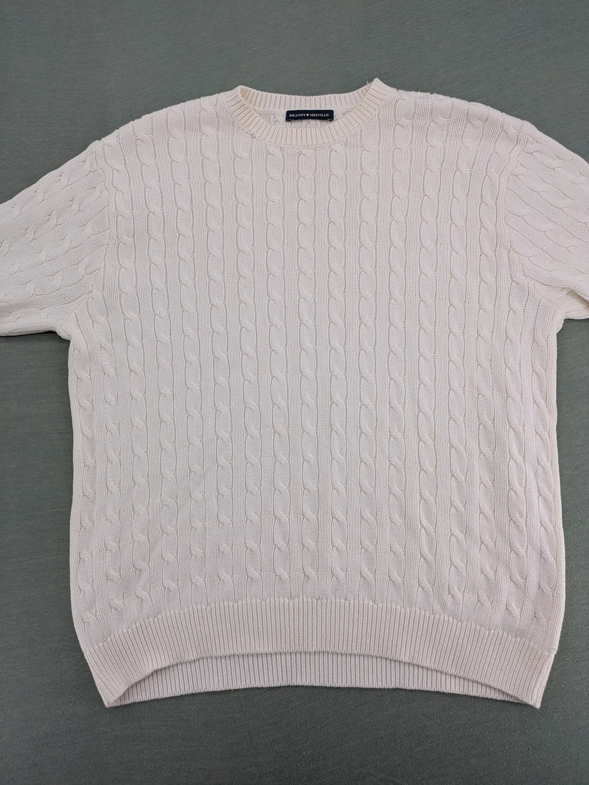Brandy Melville cream turtle neck jumper with allover cable knit pattern and ribbed hem.