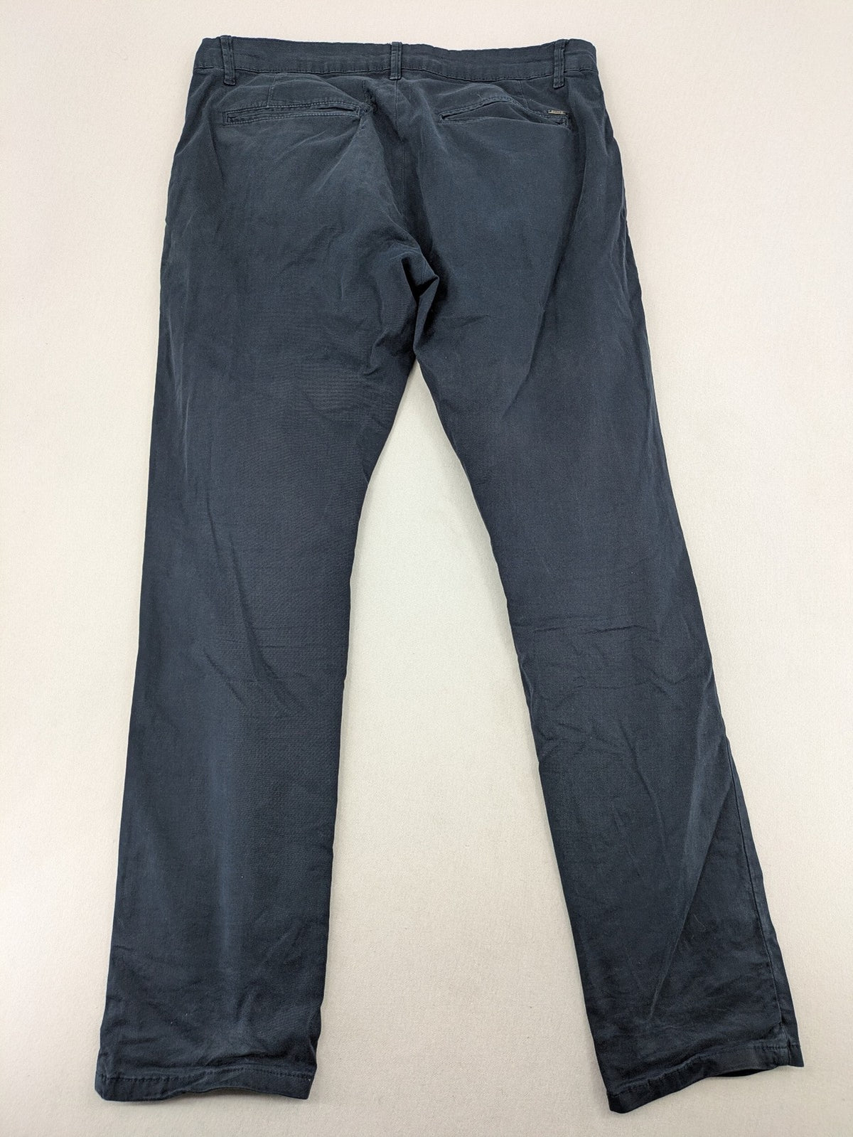 smog blue chino pants with belt loops, button fly, and side pockets