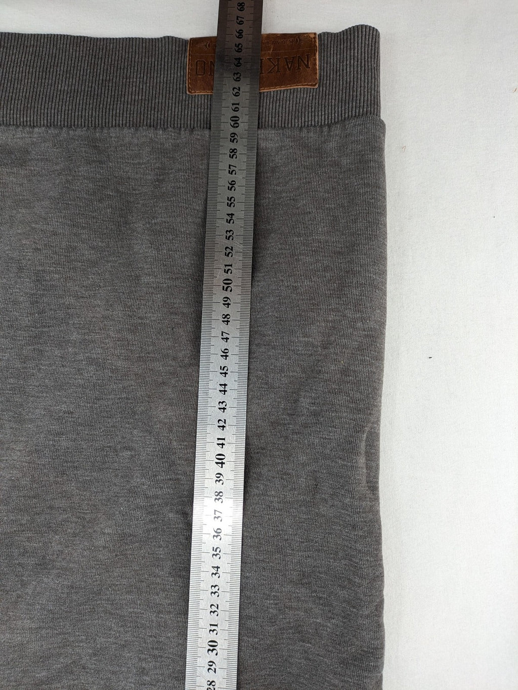 Naketano multicolor turtle neck jumper with button placket and anchor patches.