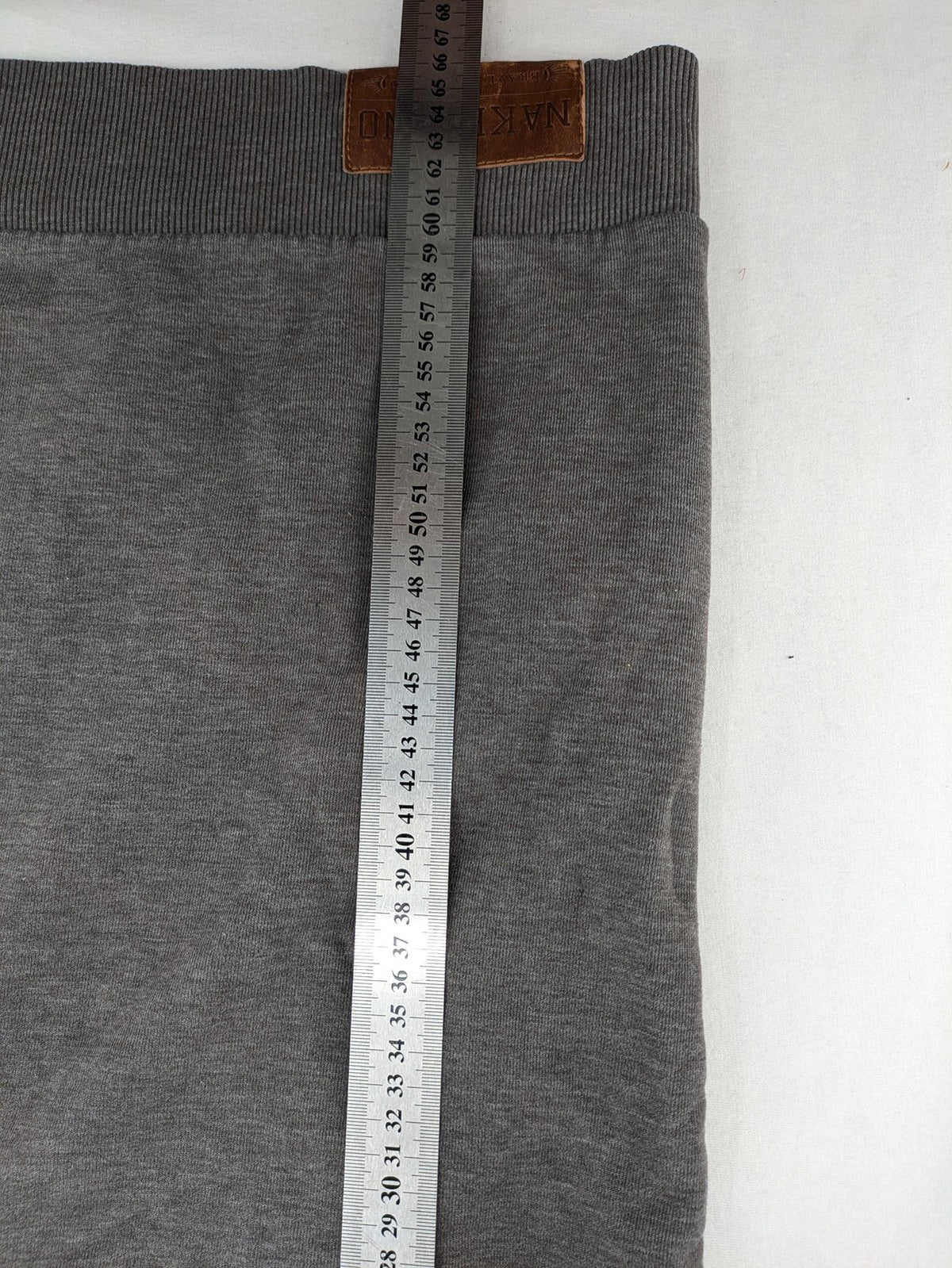 Naketano multicolor turtle neck jumper with button placket and anchor patches.