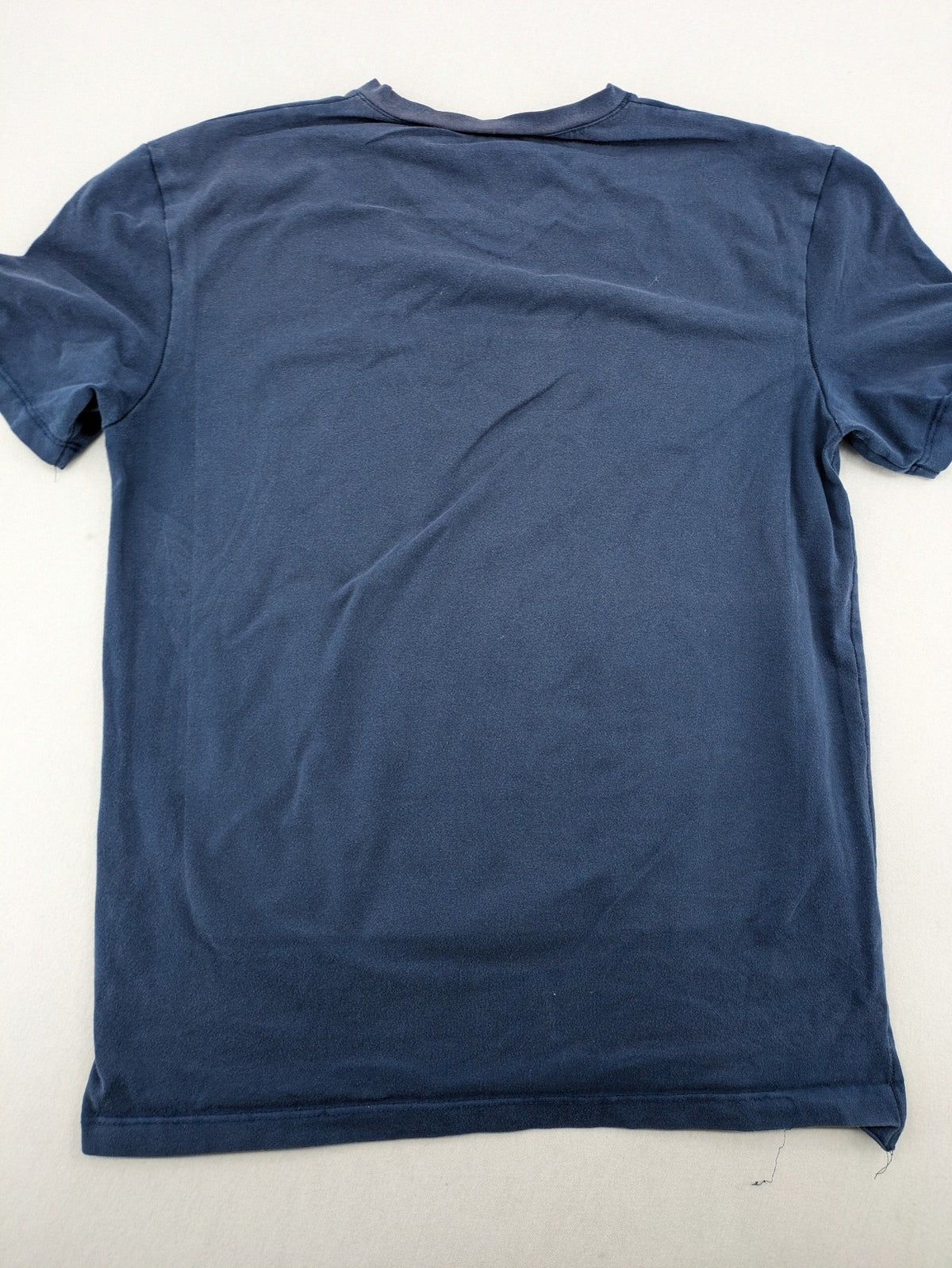 G-Unit navy vintage T-shirt with vertical logo print and V-neck design.