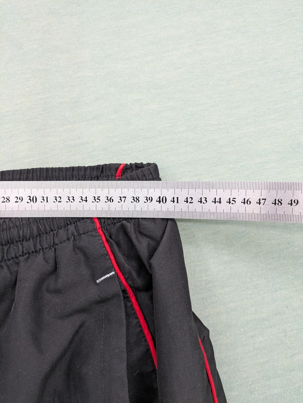 Fila grey jogging pants with red piping and embroidered logo on thigh.