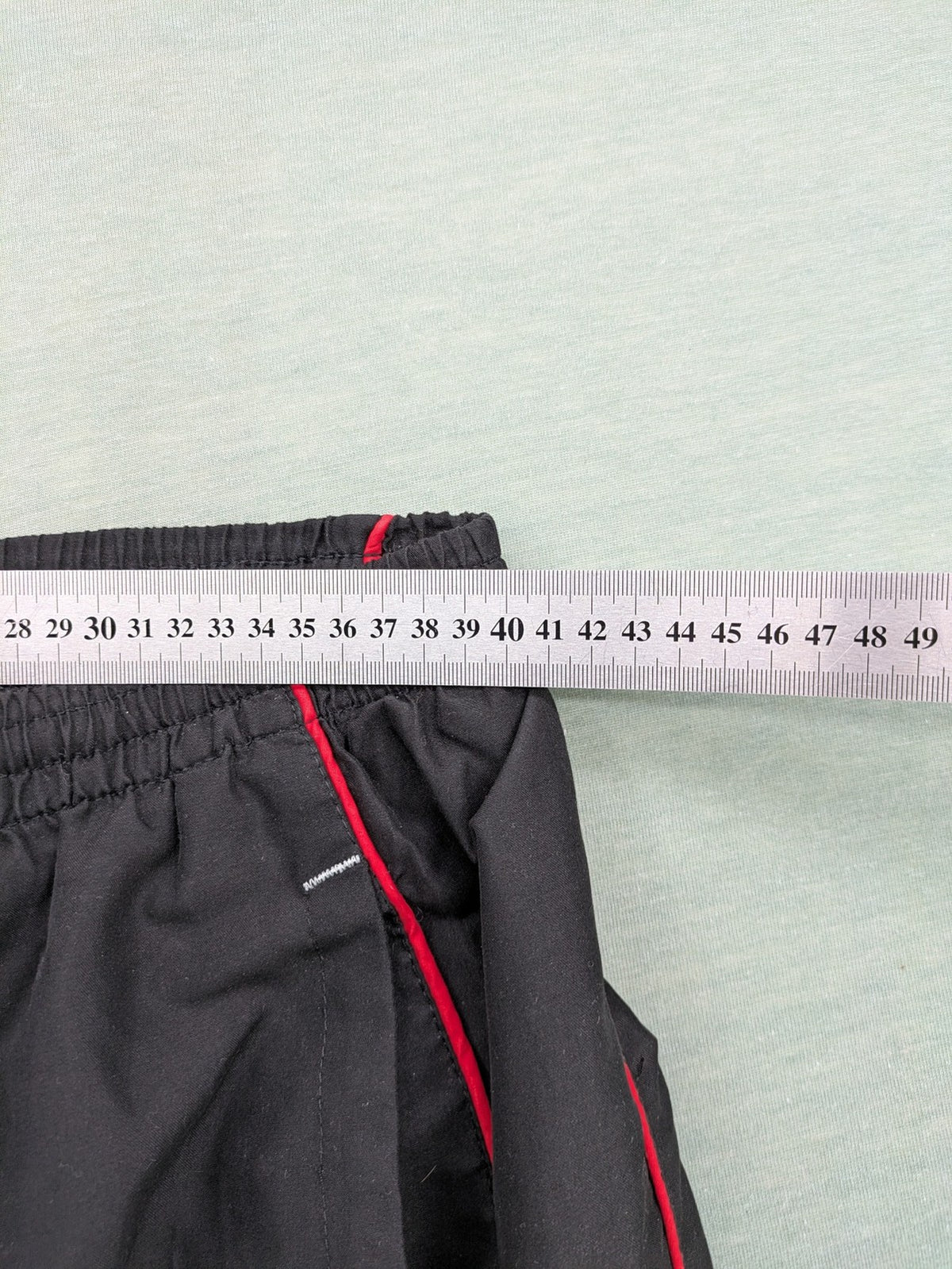 Fila grey jogging pants with red piping and embroidered logo on thigh.
