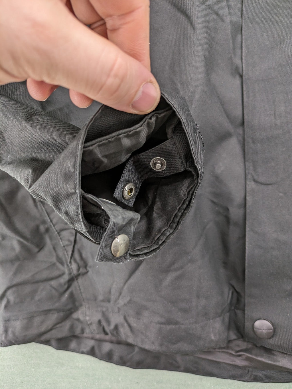Stormtech black waterproof jacket with ZF logo, H2Xtreme technology, front zipper, and hood.