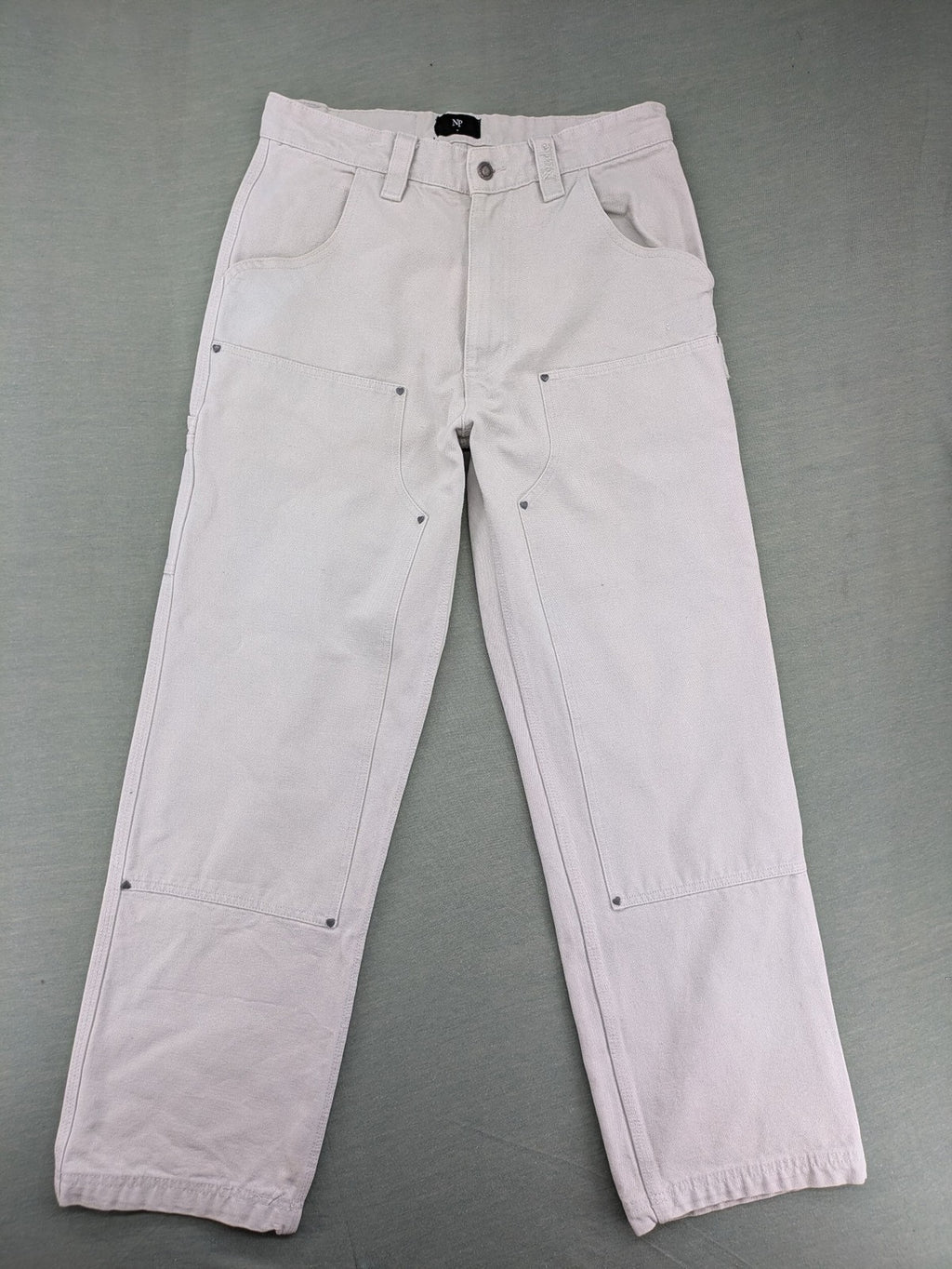 NUDE beige pants with double knee reinforcements and multiple utility pockets.