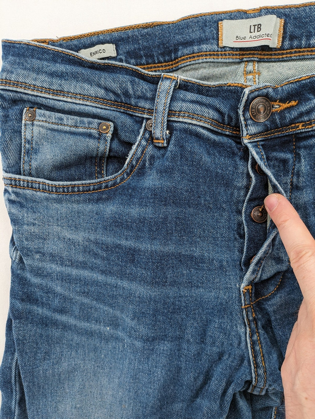 LTB blue straight jeans with low rise, button fly, and classic denim wash.