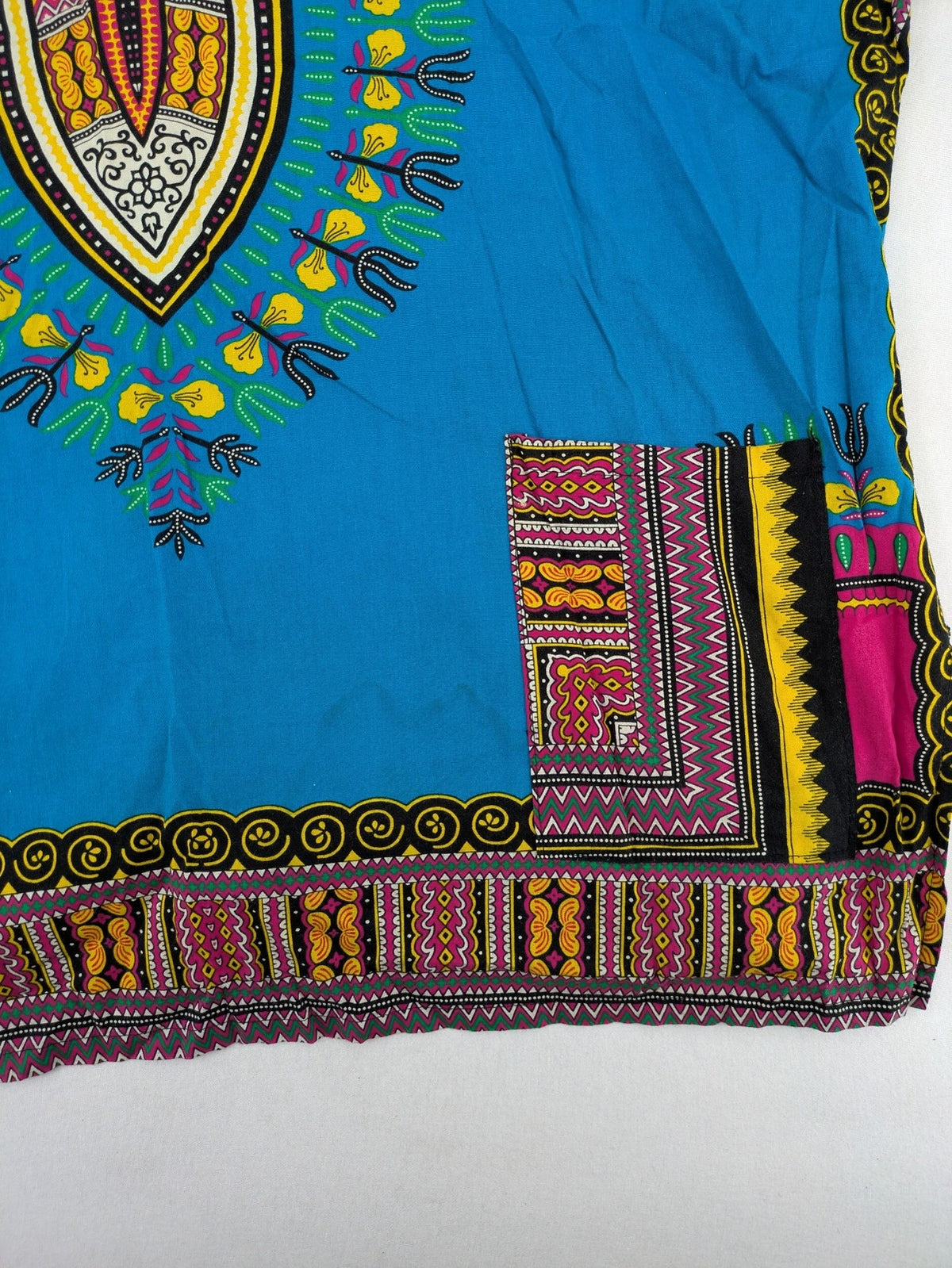 M/L multi Dashiki shirt with vibrant ethnic print on light blue cotton fabric.
